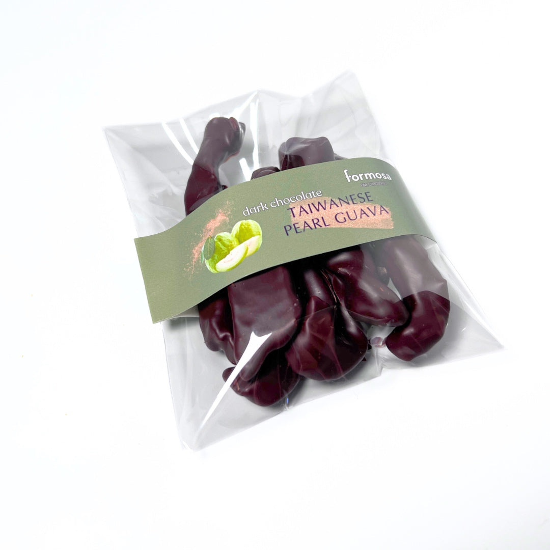 Packaged dried Taiwanese pearl guava enrobed in dark chocolate by Formosa on a white background.
