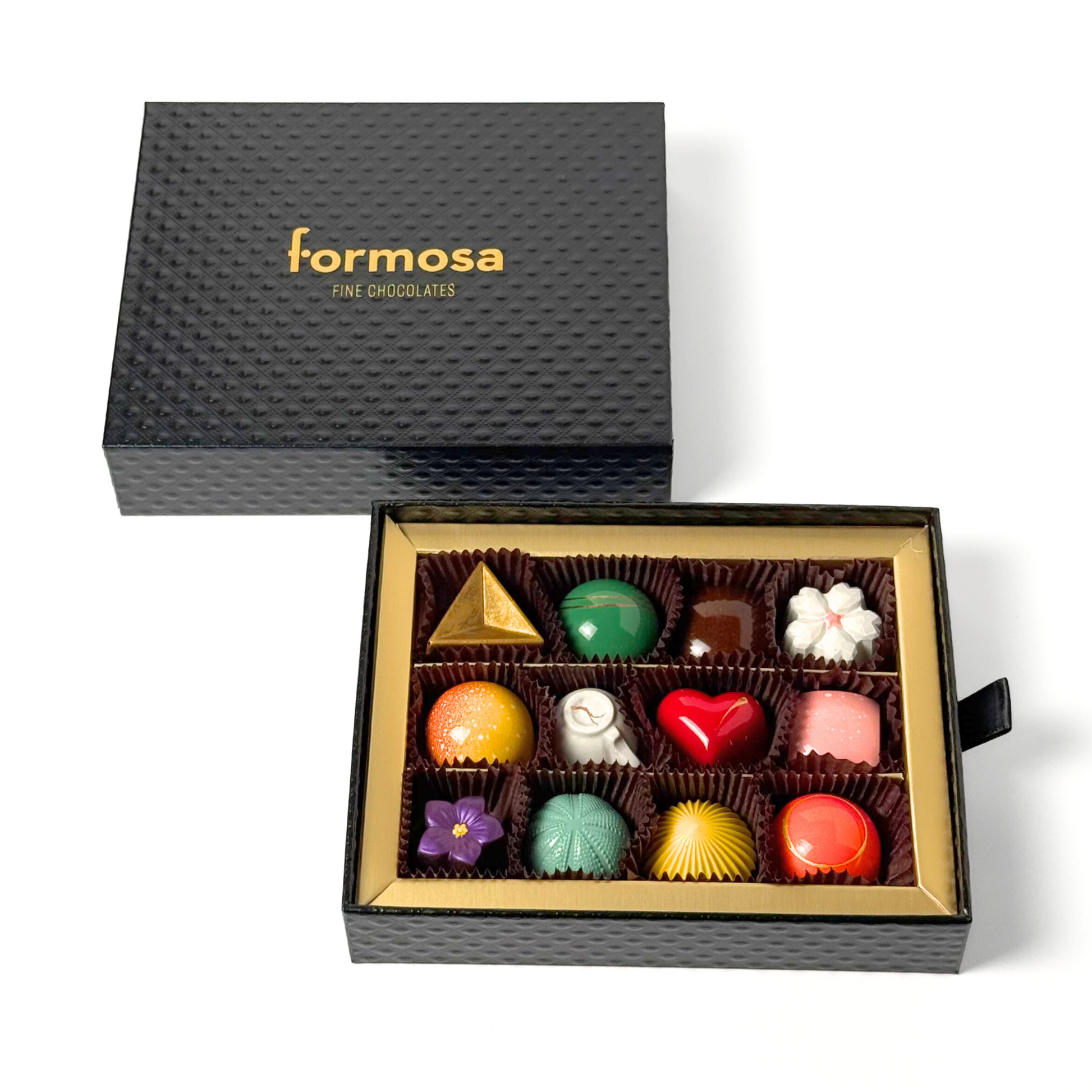 Open box of Formosa Fine Chocolates with various colorful chocolates on a white background