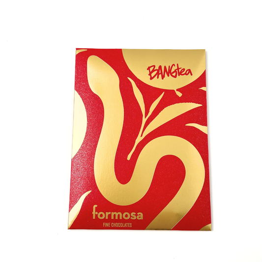 A photo of the Bang Tea Gaba Oolong chocolate bar in its red and gold packaging set against a white background. 