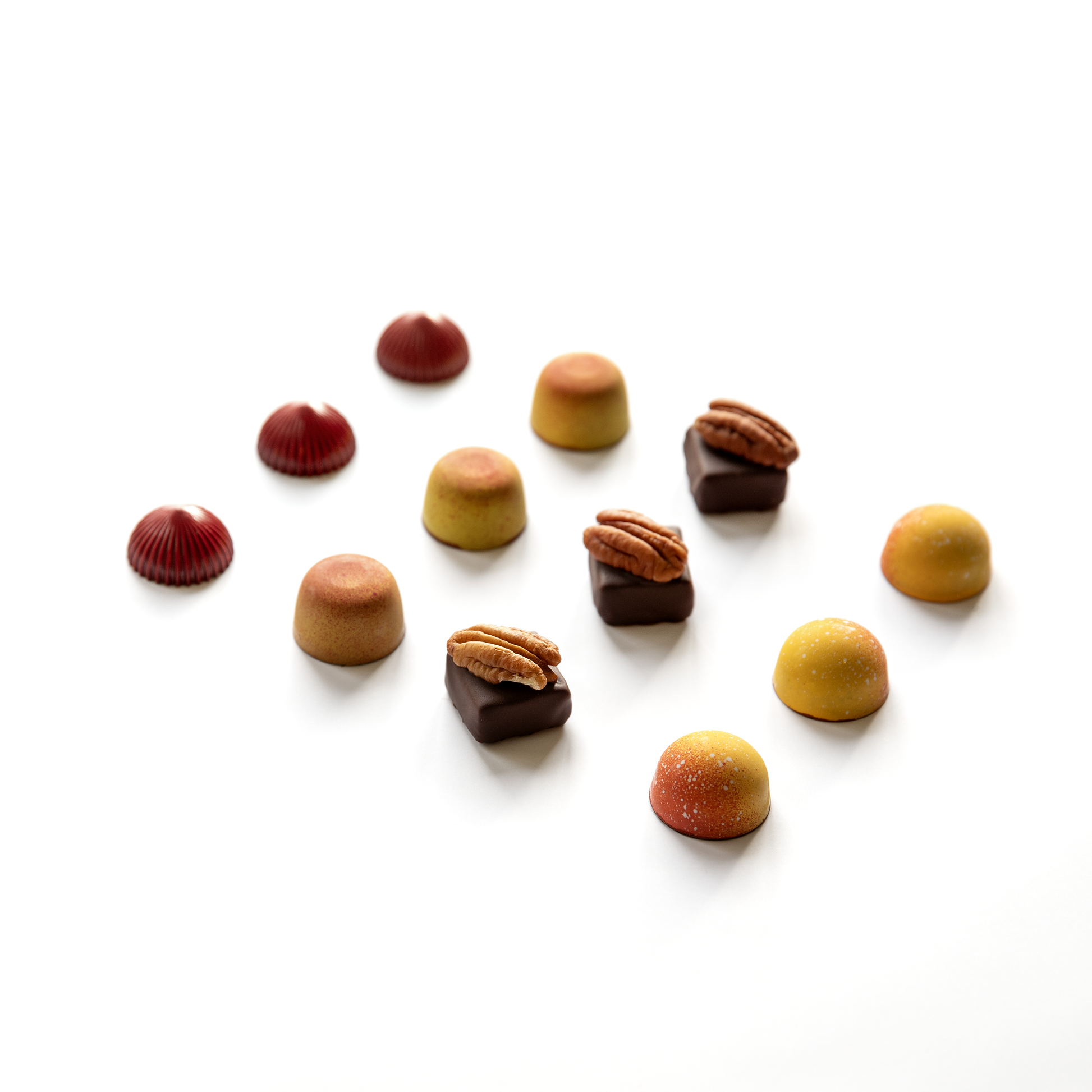 Assorted chocolates with nuts on a white background