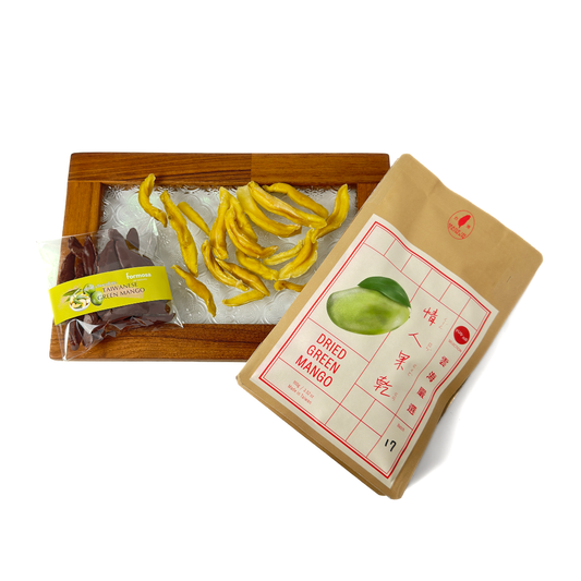A package of dried Taiwanese young green mangoes enrobed in 60% dark chocolate, next to its packaging which includes product information and branding.